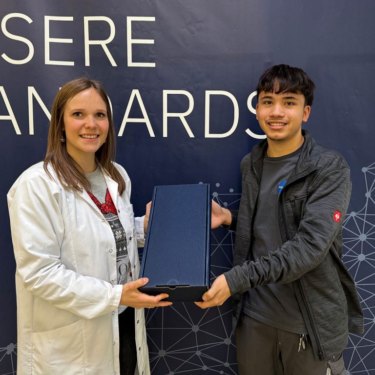 One employee hands over a present to another employee